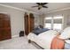 Bright bedroom with a ceiling fan, large windows and a four poster bed at 15921 Herriman Blvd, Noblesville, IN 46060