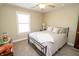Relaxing bedroom with neutral walls, a window with blinds, and a cozy bed with decorative pillows at 15921 Herriman Blvd, Noblesville, IN 46060