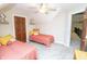 Cozy bedroom featuring twin beds, neutral walls, and a ceiling fan, offering a comfortable space at 15921 Herriman Blvd, Noblesville, IN 46060