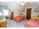 Bright bedroom with two twin beds and a ceiling fan at 15921 Herriman Blvd, Noblesville, IN 46060