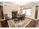 Elegant dining room with hardwood floors, a decorative rug, and a chandelier at 15921 Herriman Blvd, Noblesville, IN 46060