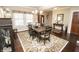 Dining area featuring a wood table, decorative rug, and an elegant light fixture at 15921 Herriman Blvd, Noblesville, IN 46060