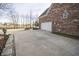 Long driveway leading to a two car garage with a brick home in the background at 15921 Herriman Blvd, Noblesville, IN 46060