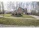 Side view of an attached garage showcasing the driveway and surrounding landscape at 15921 Herriman Blvd, Noblesville, IN 46060