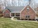 Charming brick home with a covered front porch and well-manicured lawn at 15921 Herriman Blvd, Noblesville, IN 46060
