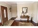 Inviting foyer featuring a wood door, hardwood floors, and decorative accents at 15921 Herriman Blvd, Noblesville, IN 46060