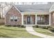 Inviting front porch featuring a seating area and manicured landscaping at 15921 Herriman Blvd, Noblesville, IN 46060