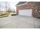 Spacious driveway leading to a clean, white garage door, highlighting outdoor maintenance at 15921 Herriman Blvd, Noblesville, IN 46060