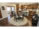 Open kitchen dining area with a glass table and adjacent kitchen at 15921 Herriman Blvd, Noblesville, IN 46060