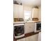 Bright laundry room featuring white cabinets, modern washer and dryer, and a functional sink area at 15921 Herriman Blvd, Noblesville, IN 46060