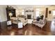 Cozy living room with a fireplace, hardwood floors, and comfortable seating at 15921 Herriman Blvd, Noblesville, IN 46060