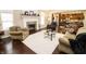 Inviting living room with fireplace, hardwood floors, and a seamless flow to the kitchen at 15921 Herriman Blvd, Noblesville, IN 46060