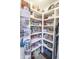 Well-stocked pantry with organized shelving filled with canned goods, bottles, and various kitchen essentials at 15921 Herriman Blvd, Noblesville, IN 46060