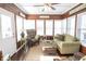 Cozy sunroom with wood-paneled walls and a comfortable seating area at 15921 Herriman Blvd, Noblesville, IN 46060