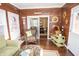 Charming sunroom featuring rustic wood paneling and sliding door to dining area at 15921 Herriman Blvd, Noblesville, IN 46060