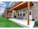 Backyard patio with brick exterior, seating, and lush green lawn for outdoor enjoyment at 16057 Coleman Dr, Westfield, IN 46074