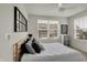 Bright bedroom with a large window, ceiling fan, and a comfortable bed with stylish pillows at 16057 Coleman Dr, Westfield, IN 46074