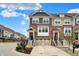 The townhome has brick and siding exterior with a two-car garage, front landscaping, and blue sky at 16057 Coleman Dr, Westfield, IN 46074