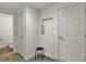 Hallway with hooks, bench, and visible partial bathroom with neutral-toned decor at 16057 Coleman Dr, Westfield, IN 46074