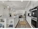 The open kitchen features an island, pendant lights, modern appliances, and neutral tones at 16057 Coleman Dr, Westfield, IN 46074