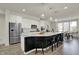 Bright kitchen features stainless steel appliances, white cabinets and a large island with pendant lighting at 16057 Coleman Dr, Westfield, IN 46074