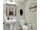 Tastefully decorated powder room featuring a pedestal sink and modern fixtures at 16057 Coleman Dr, Westfield, IN 46074