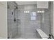 Modern walk-in shower with gray marble tile and a built-in bench at 16057 Coleman Dr, Westfield, IN 46074