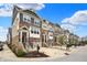 Townhomes with brick and siding exteriors, landscaped front yards, and inviting entryways on a sunny day at 16057 Coleman Dr, Westfield, IN 46074