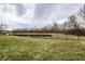 Expansive backyard with a scenic pond view, enhanced by lush greenery and a classic fence line at 16882 Oak Manor Dr, Westfield, IN 46074