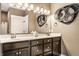 A bathroom with a double sink vanity, a large mirror, stylish lighting and decorative wall art at 16882 Oak Manor Dr, Westfield, IN 46074
