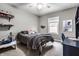 Comfortable bedroom with a twin bed, a ceiling fan, built-in shelving and a window view at 16882 Oak Manor Dr, Westfield, IN 46074