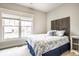 A well-lit bedroom showcasing a charming bed with decorative pillows and a view through the bright window at 16882 Oak Manor Dr, Westfield, IN 46074