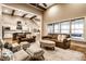 Bright living room featuring vaulted ceilings, exposed beams, fireplace, and large windows offering lots of natural light at 16882 Oak Manor Dr, Westfield, IN 46074