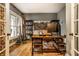 Well-lit home office featuring hardwood floors, built-in shelving, a spacious desk, and charming decor at 16882 Oak Manor Dr, Westfield, IN 46074