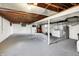 Unfinished basement with exposed ceiling, concrete floor, and laundry area at 1901 E Edgewood Ave, Indianapolis, IN 46227