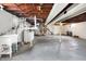 Unfinished basement with exposed ductwork, concrete floor, and laundry hookups at 1901 E Edgewood Ave, Indianapolis, IN 46227