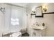 Traditional bathroom featuring a vanity with framed mirror, and a shower with a white curtain at 1901 E Edgewood Ave, Indianapolis, IN 46227