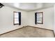 Bright bedroom featuring neutral carpet and two windows with shades at 1901 E Edgewood Ave, Indianapolis, IN 46227