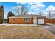 Charming brick home features an attached garage, manicured lawn and lovely landscaping at 1901 E Edgewood Ave, Indianapolis, IN 46227