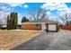 Well-maintained brick home with attached garage, mature trees, and long driveway at 1901 E Edgewood Ave, Indianapolis, IN 46227