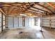 The garage has an open ceiling with a concrete floor and two overhead doors for easy access at 1901 E Edgewood Ave, Indianapolis, IN 46227