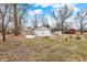 View of a detached two-car garage with white doors next to a home with a bright red exterior at 1901 E Edgewood Ave, Indianapolis, IN 46227