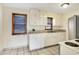 Practical kitchen with classic white cabinets, tile counters, and neutral flooring at 1901 E Edgewood Ave, Indianapolis, IN 46227