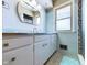 Bathroom featuring blue tile walls, modern sink with storage, and a large mirror at 2021 E 9Th St, Anderson, IN 46012