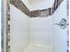 Tiled shower with recessed shelving and modern fixtures provide a spa-like experience at 2021 E 9Th St, Anderson, IN 46012