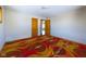 Cozy bedroom with a large window and unique, colorful patterned carpet at 2021 E 9Th St, Anderson, IN 46012
