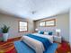 Relaxing bedroom showcasing a comfortable bed with blue accents and natural light at 2021 E 9Th St, Anderson, IN 46012