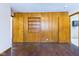 Bedroom with wood-paneled walls and built-in shelves, offering ample storage space at 2021 E 9Th St, Anderson, IN 46012