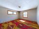 Bedroom with natural light, featuring a distinctive colorful carpet and two windows at 2021 E 9Th St, Anderson, IN 46012