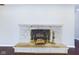 Close up of a stone fireplace with decorative brass accessories on the hearth at 2021 E 9Th St, Anderson, IN 46012